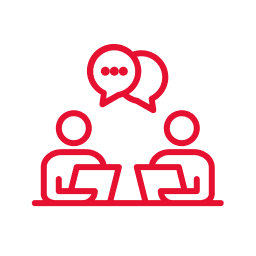 Two people on laptops having a conversation.